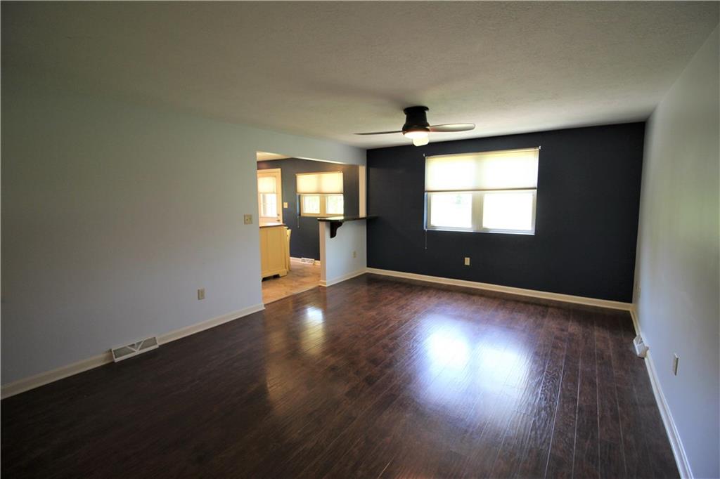 The dining area with ceiling fan is open to the kitchen with a serving/breakfast bar in between. A great home for entertaining.