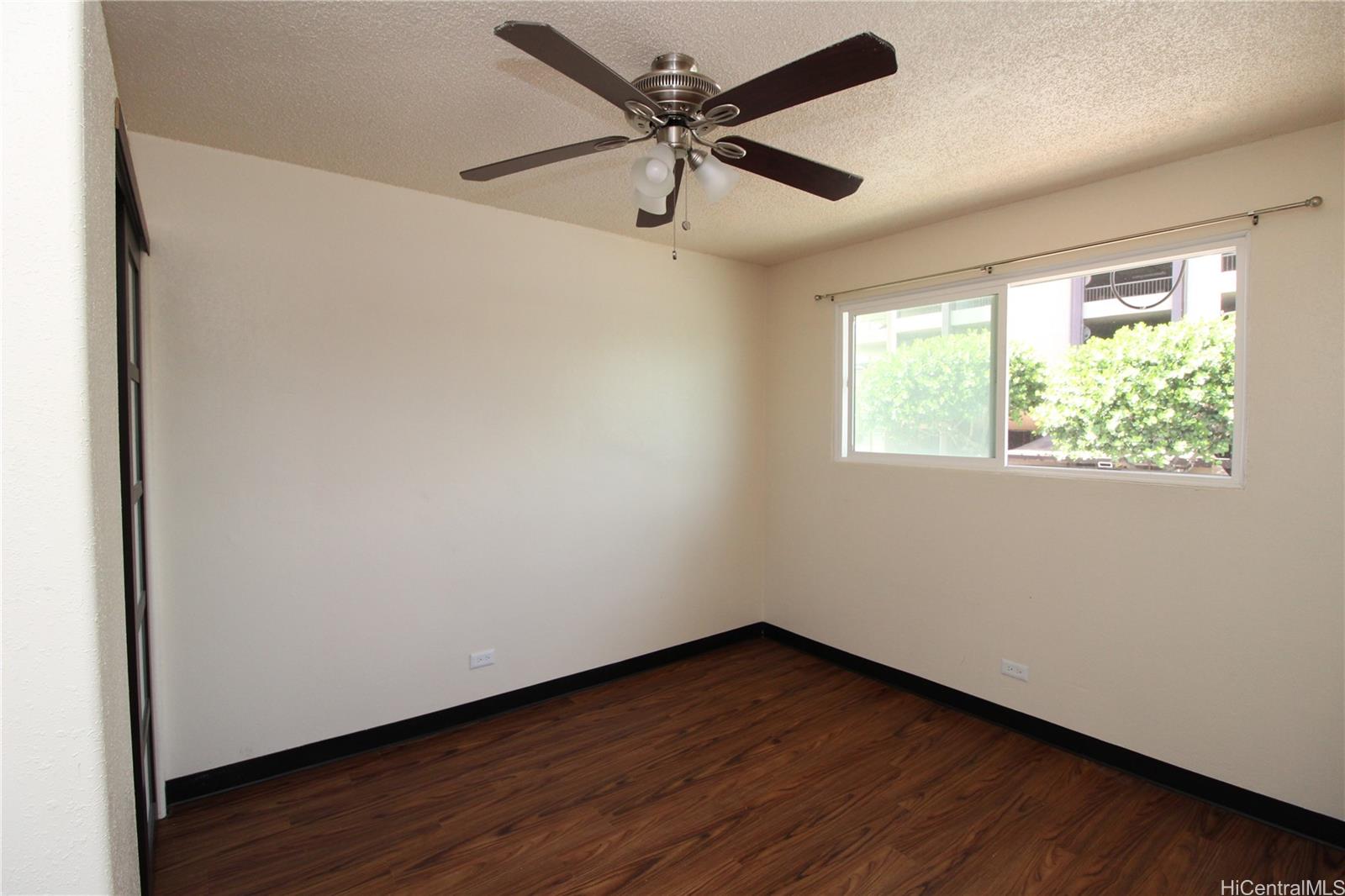2503 Ala Wai Boulevard, Unit F Honolulu, HI 96815 - Photo 3 of 8 an empty room with wooden floor and windows