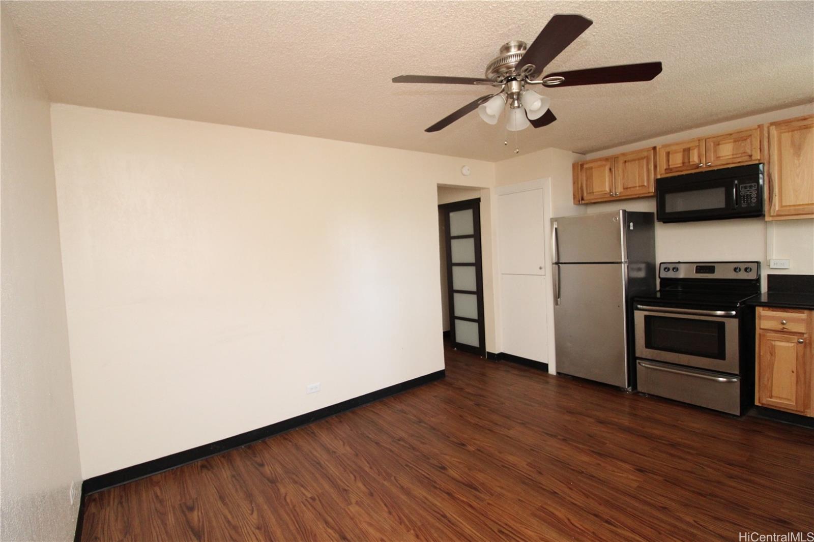 2503 Ala Wai Boulevard, Unit F Honolulu, HI 96815 - Photo 5 of 8 a kitchen with a refrigerator and a microwave