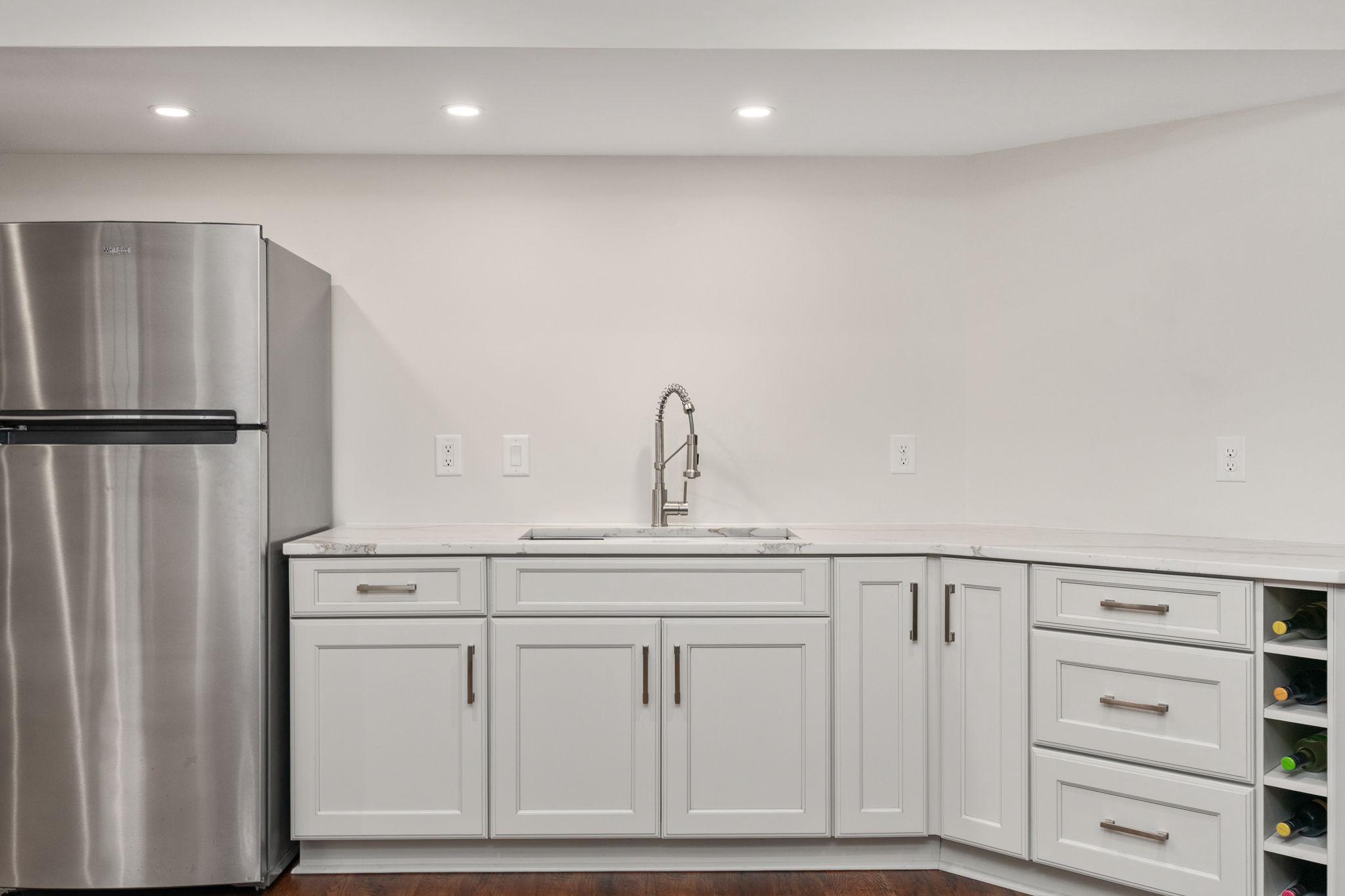 9417 Reservoir Road Fredericksburg, VA 22407 - Photo 37 of 76 a kitchen with white cabinets and refrigerator