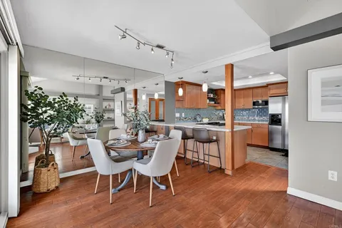 a view of a dining room with furniture and wooden floor