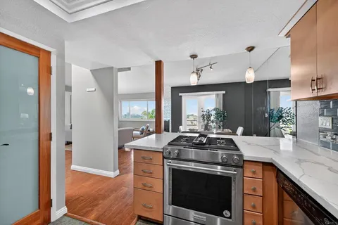 a kitchen with stainless steel appliances granite countertop a stove a sink and a granite counter tops
