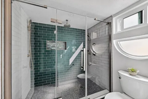 a bathroom with a toilet a sink and shower