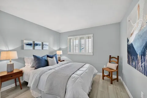 a bedroom with a bed and a lamp with window