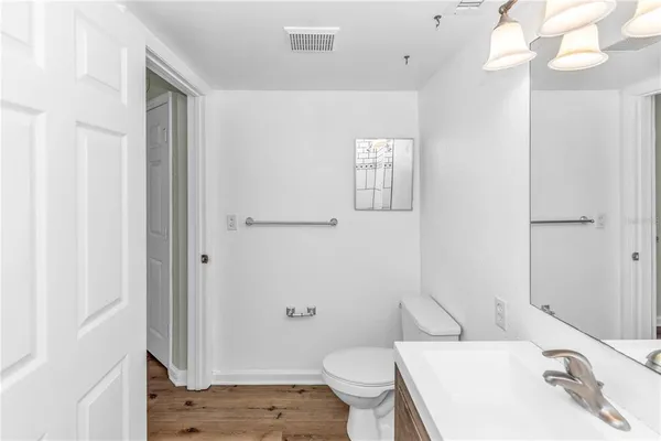 a bathroom with a sink toilet vanity and shower