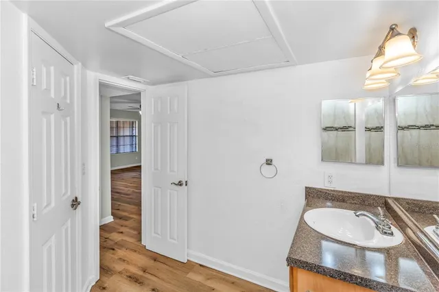 a bathroom with a granite countertop sink and a mirror