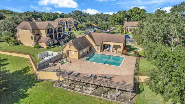 an aerial view of a house with swimming pool and big yard