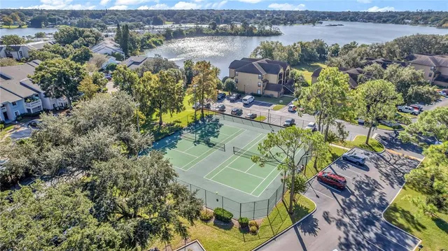 an aerial view of a house with a garden and lake view