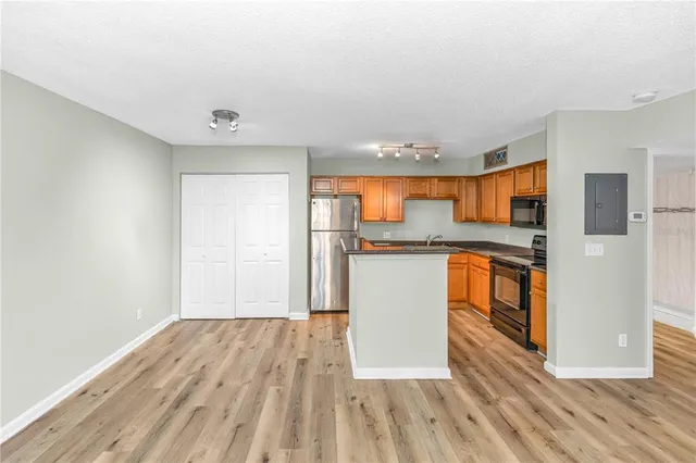 a view of a kitchen with wooden floor