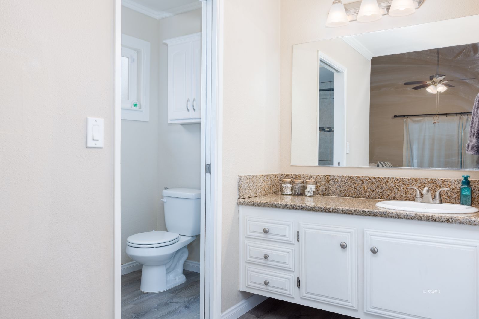640 Peg Street Ridgecrest, CA 93555 - Photo 12 of 25 a bathroom with a granite countertop toilet sink and mirror