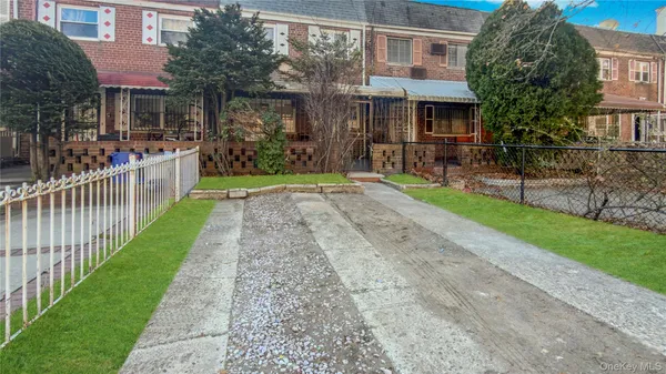 a front view of a house with a yard and table and chairs