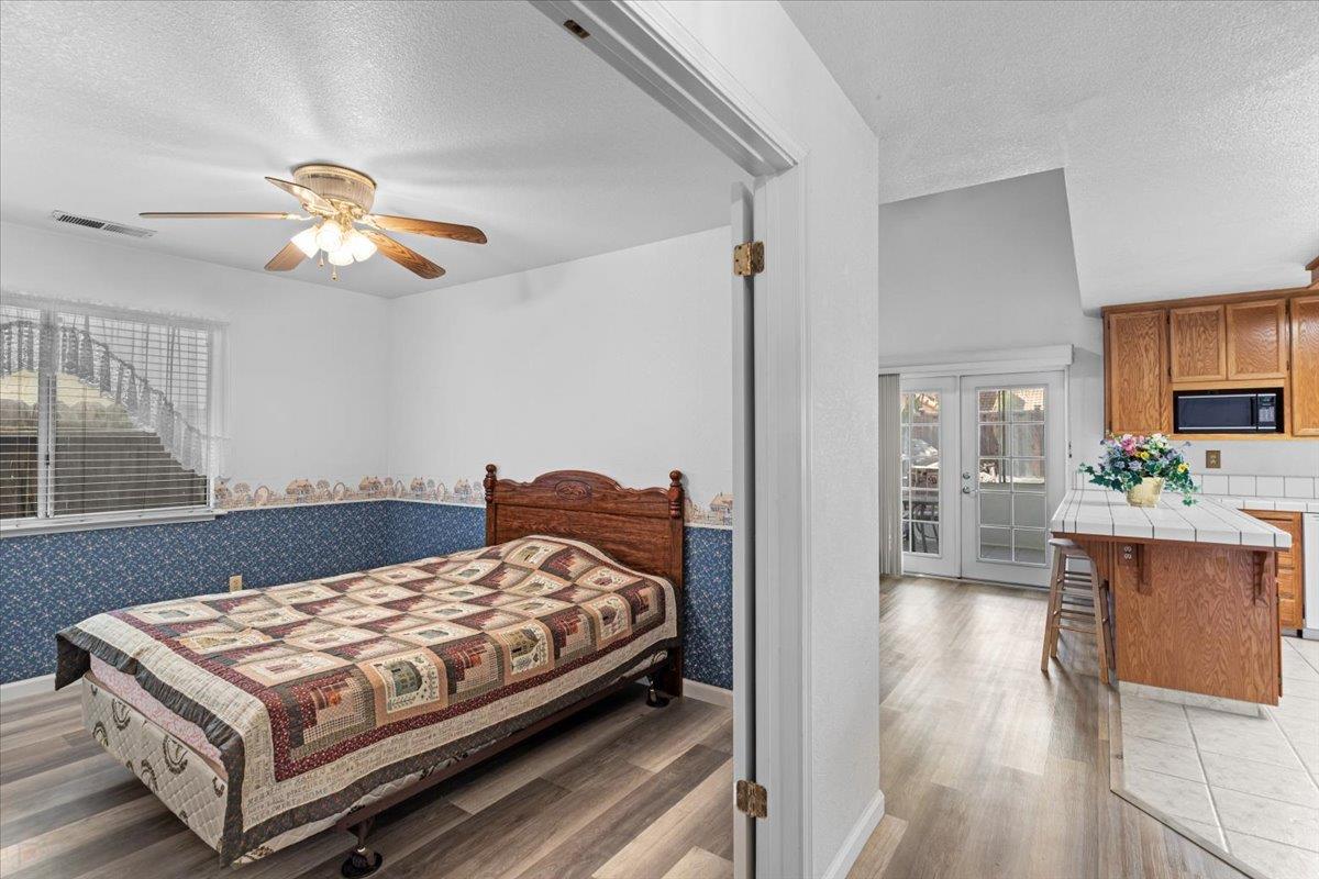 3005 Willetts Way Ceres, CA 95307 - Photo 12 of 29 a bedroom with a bed and a chandelier