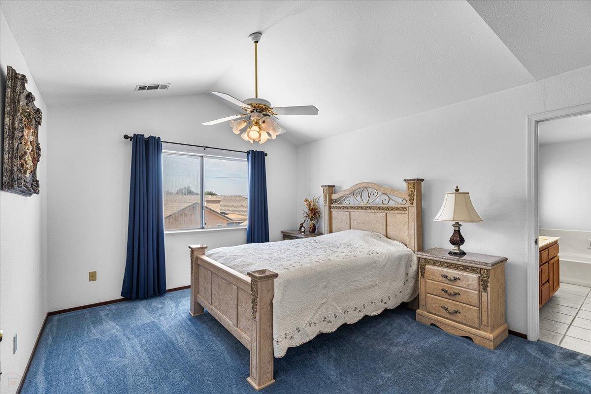3005 Willetts Way Ceres, CA 95307 - Photo 17 of 29 a bedroom with a bed chandelier and a window