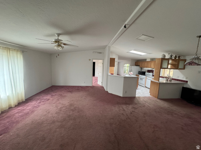 580 East 400 North Spring City, UT 84662 - Photo 6 of 40 Unfurnished living room with light carpet, ceiling fan, and a textured ceiling