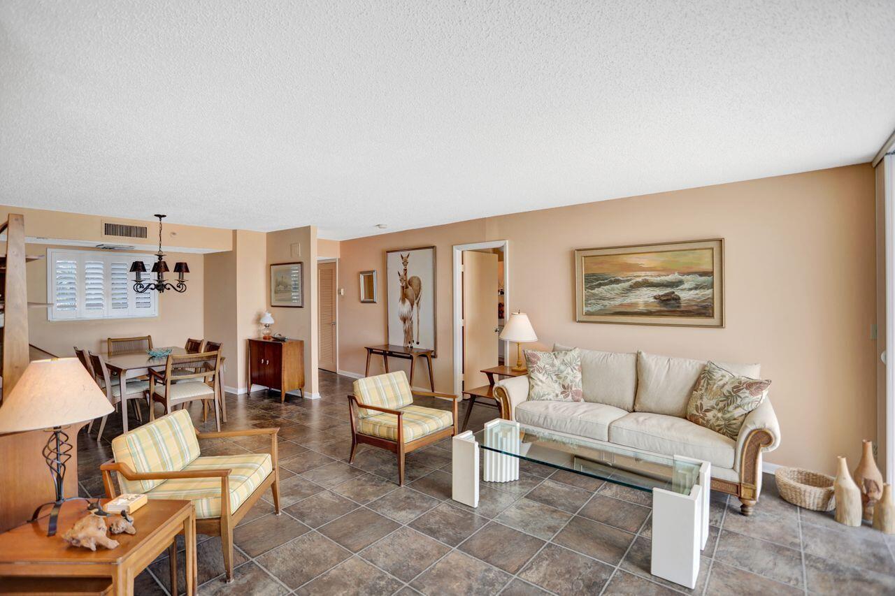 100 Ocean Trail Way, Unit 109 Jupiter, FL 33477 - Photo 4 of 27 a living room with furniture and a potted plant