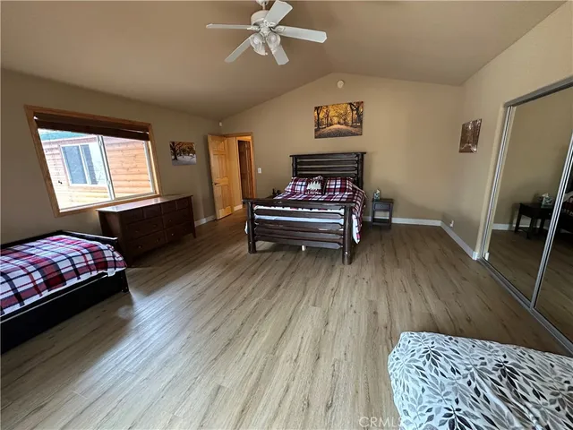 a bedroom with furniture and a wooden floor