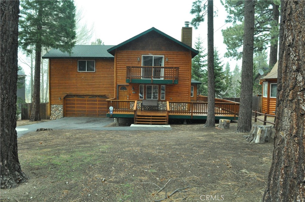 43632 Shasta Road Big Bear Lake, CA 92315 - Photo 2 of 30 a view of backyard with wooden fence and a large tree