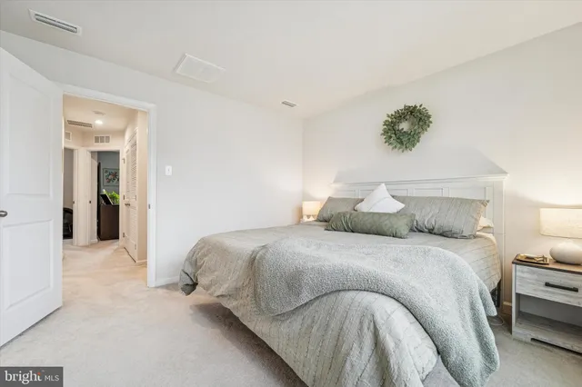 a bedroom with a bed and a painting