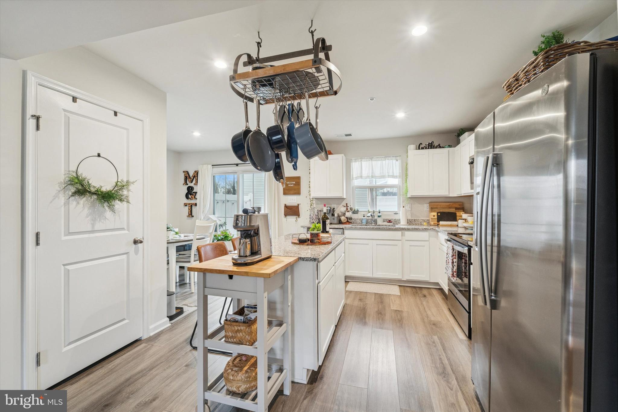 139 Nelson Lane Pottstown, PA 19464 - Photo 4 of 18 a kitchen with stainless steel appliances a refrigerator a stove a sink dishwasher and a dining table with wooden floor