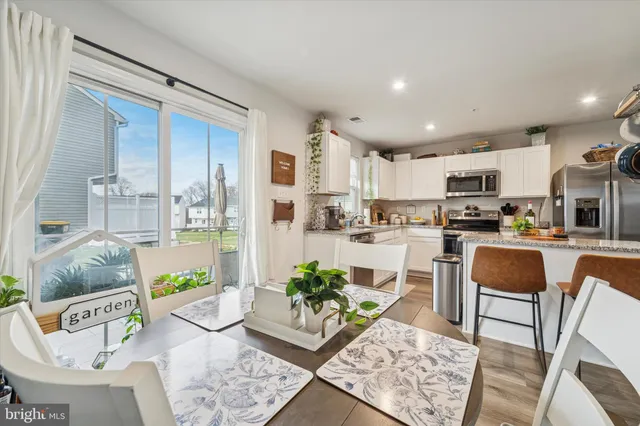 a living room with kitchen island furniture and a floor to kitchen