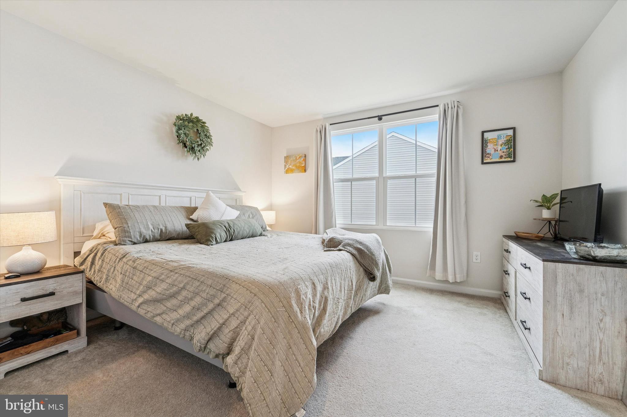 139 Nelson Lane Pottstown, PA 19464 - Photo 10 of 18 a bedroom with a bed and a flat tv screen on the dresser