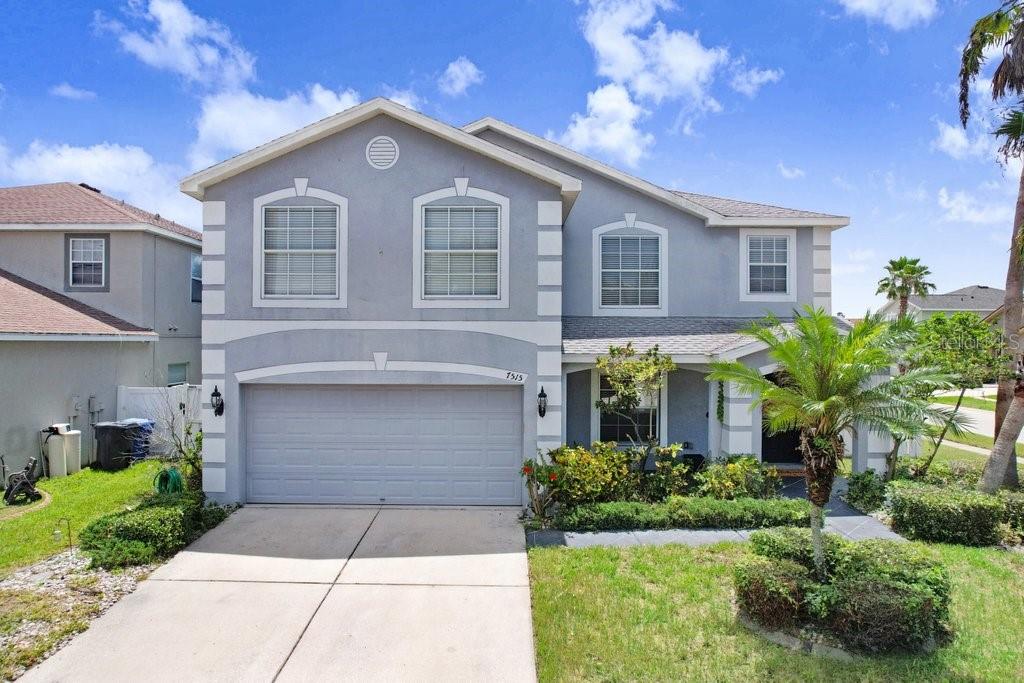 7515 Dragon Fly Loop Gibsonton, FL 33534 - Photo 1 of 1 a front view of a house with a yard and garage