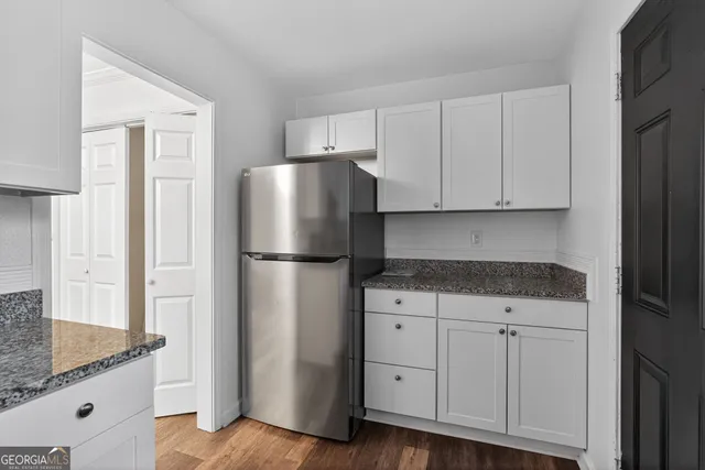 a kitchen with cabinets stainless steel appliances and a counter space