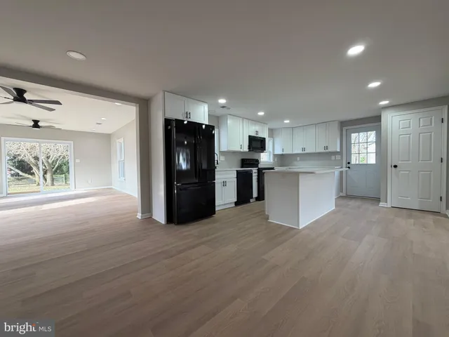 a view of kitchen appliances wooden floor and window