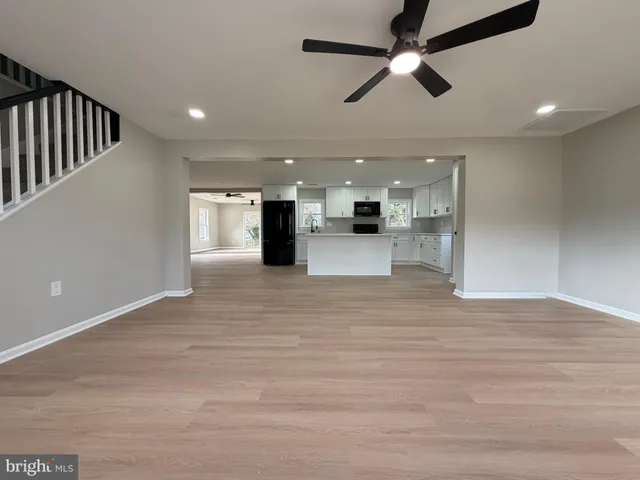 a view of kitchen with refrigerator and ceiling fan
