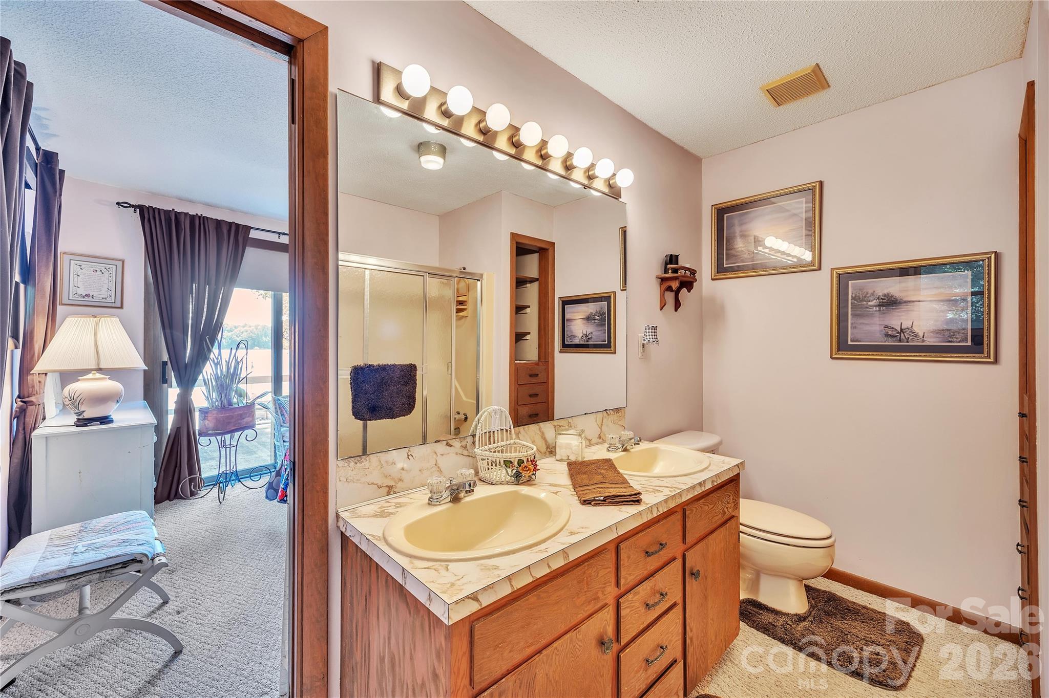 630 Mainsail Road Salisbury, NC 28146 - Photo 26 of 44 a bathroom with a toilet a sink and mirror