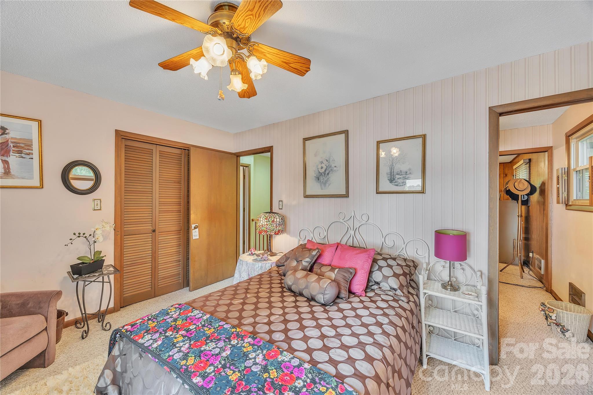 630 Mainsail Road Salisbury, NC 28146 - Photo 29 of 44 a bedroom with a bed dresser and a chandelier