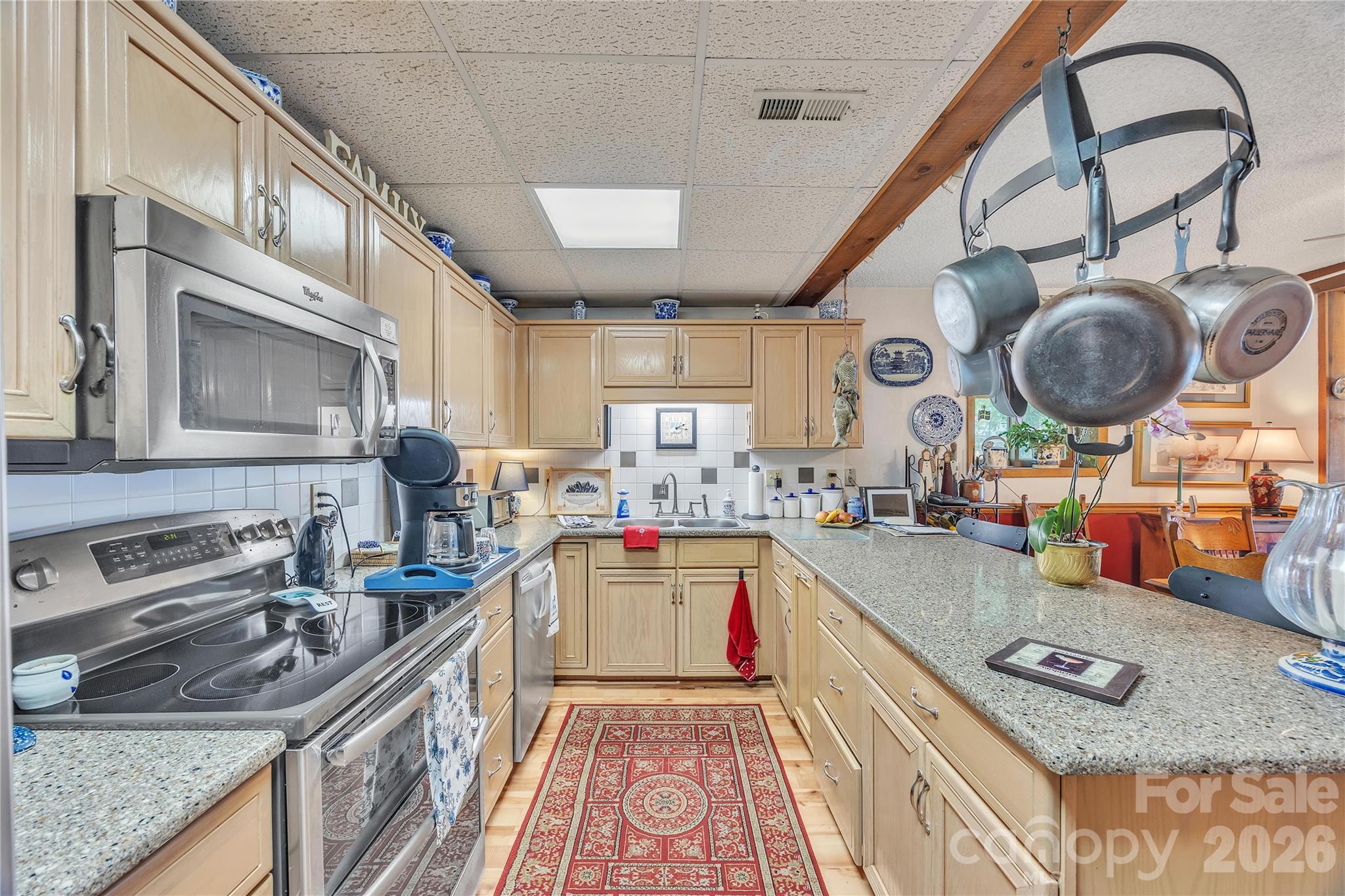 630 Mainsail Road Salisbury, NC 28146 - Photo 4 of 44 a kitchen with a stove a sink and a wooden cabinets