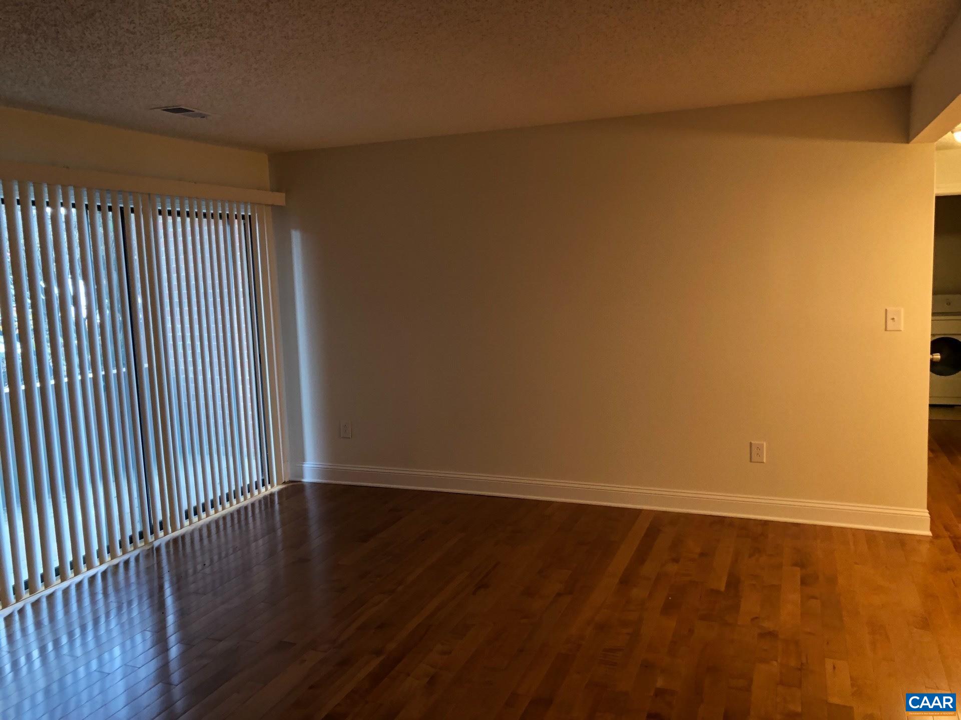 110 Turtle Creek Road, Unit 4 Charlottesville, VA 22901 - Photo 1 of 3 a view of wooden floor and brick walls
