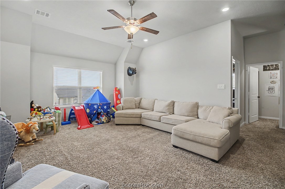 2111 Markley Drive Bryan, TX 77807 - Photo 20 of 30 a living room with furniture and a chandelier