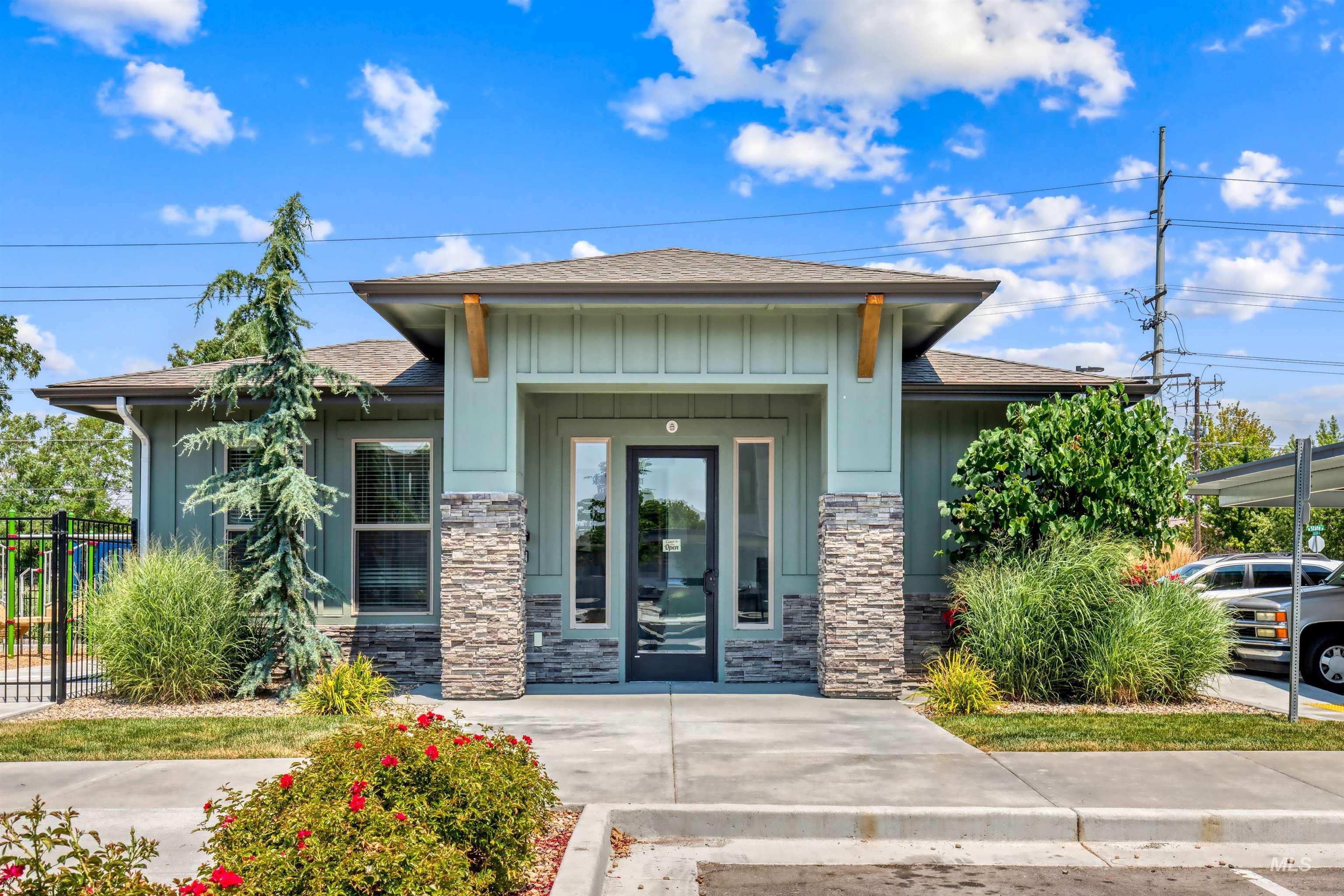 3126 East Victory Road Nampa, ID 83687 - Photo 4 of 9 Entrance to property featuring a shingled roof, board and batten siding, and stone siding