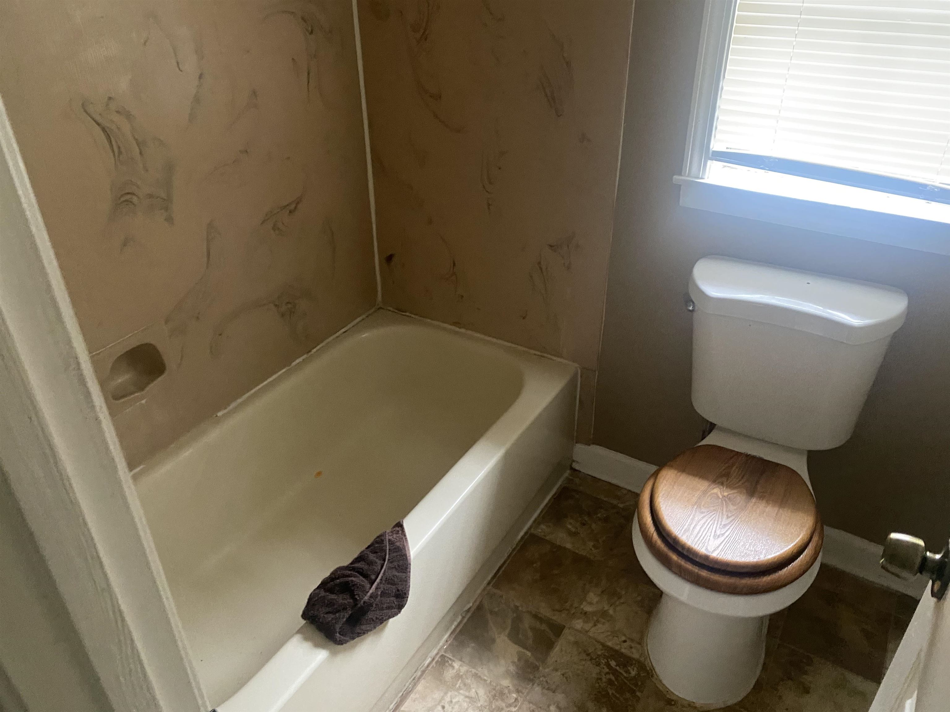3051 Knight Road Memphis, TN 38118 - Photo 16 of 18 a white toilet sitting next to a bath tub