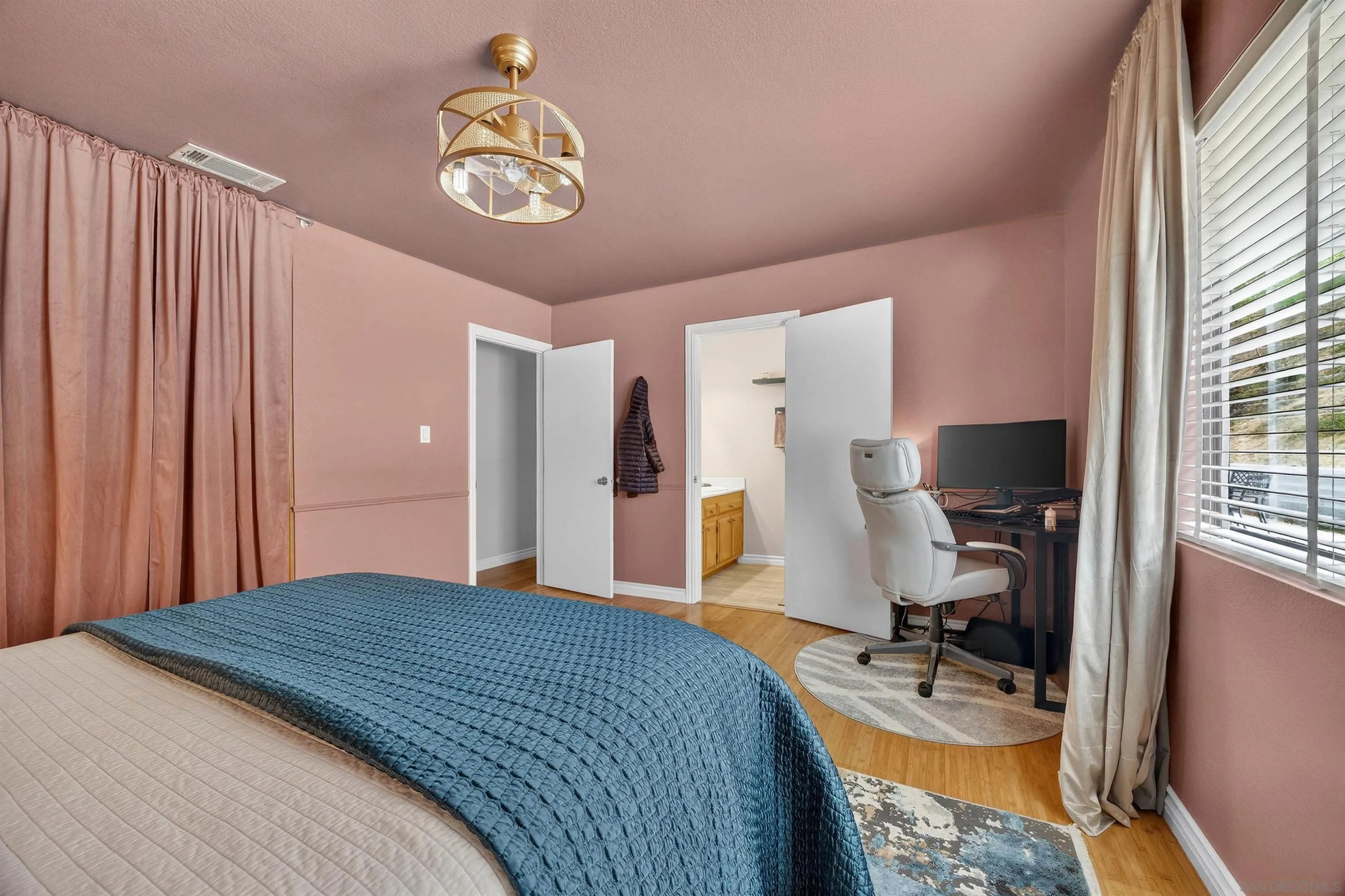 32721 Mountain View Road Bonsall, CA 92003 - Photo 12 of 33 a bedroom with a bed and a chandelier