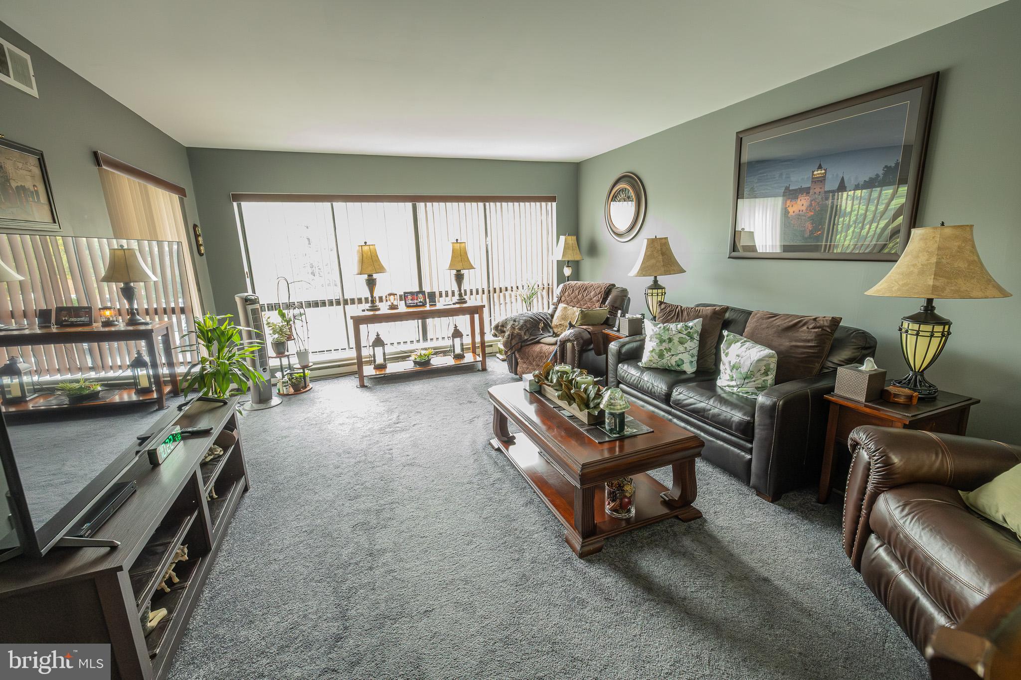 1680 Huntingdon Pike, Unit 210 Huntingdon Valley, PA 19006 - Photo 12 of 36 a living room with furniture and a large window