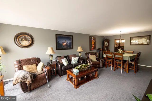 a view of a dining room with furniture and chandelier