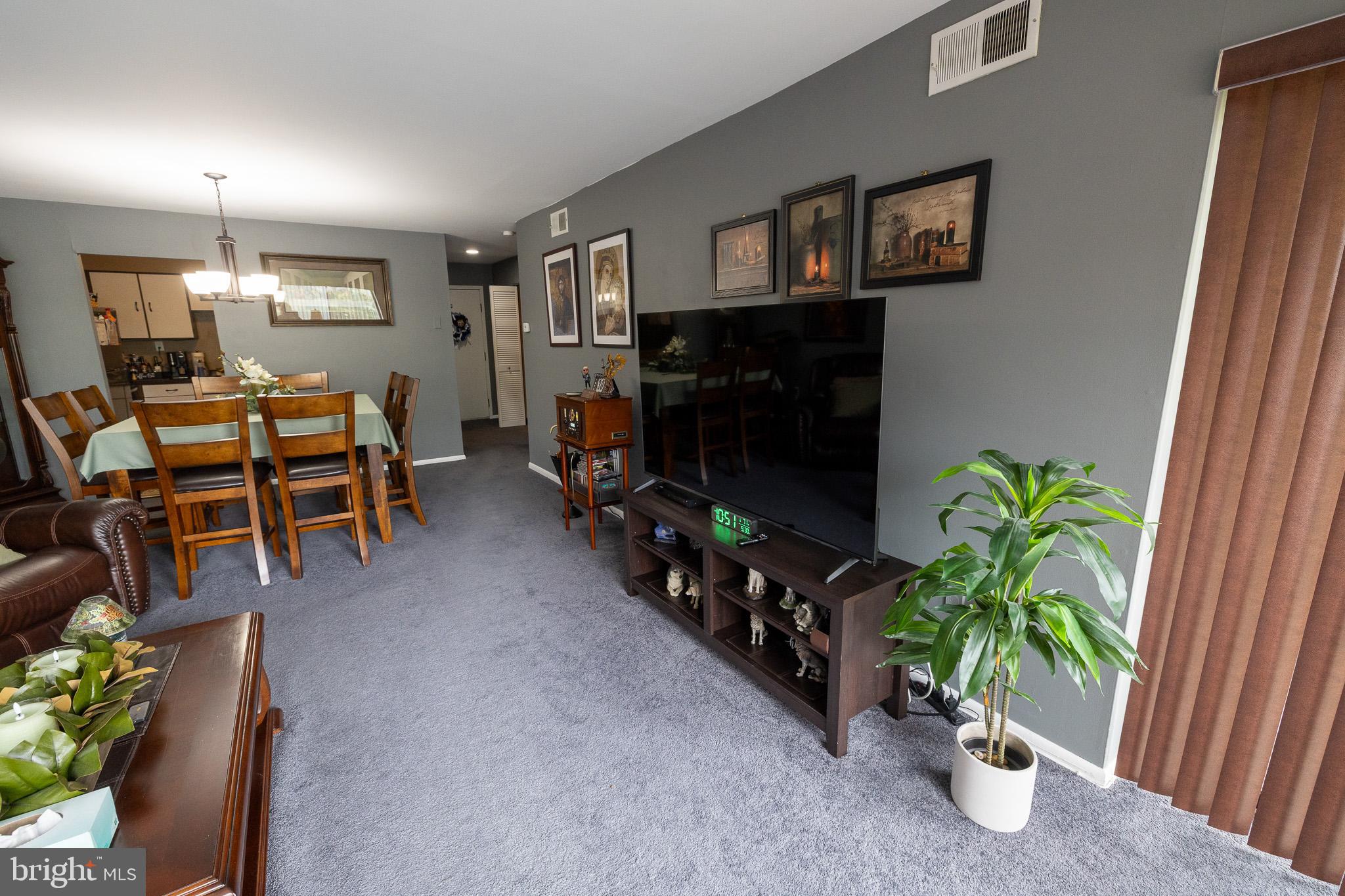 1680 Huntingdon Pike, Unit 210 Huntingdon Valley, PA 19006 - Photo 15 of 36 a living room with furniture potted plant and a flat screen tv