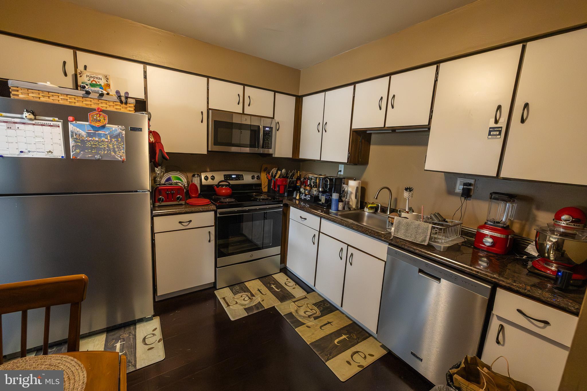 1680 Huntingdon Pike, Unit 210 Huntingdon Valley, PA 19006 - Photo 19 of 36 a kitchen with stainless steel appliances kitchen island granite countertop a refrigerator sink and cabinets
