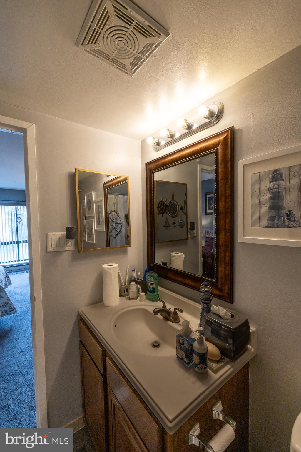 1680 Huntingdon Pike, Unit 210 Huntingdon Valley, PA 19006 - Photo 26 of 36 a bathroom with a sink a vanity and a mirror