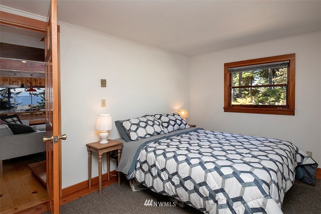 5837 Mutiny Bay Road Freeland, WA 98249 - Photo 12 of 40 a large bed sitting in a bedroom next to a window