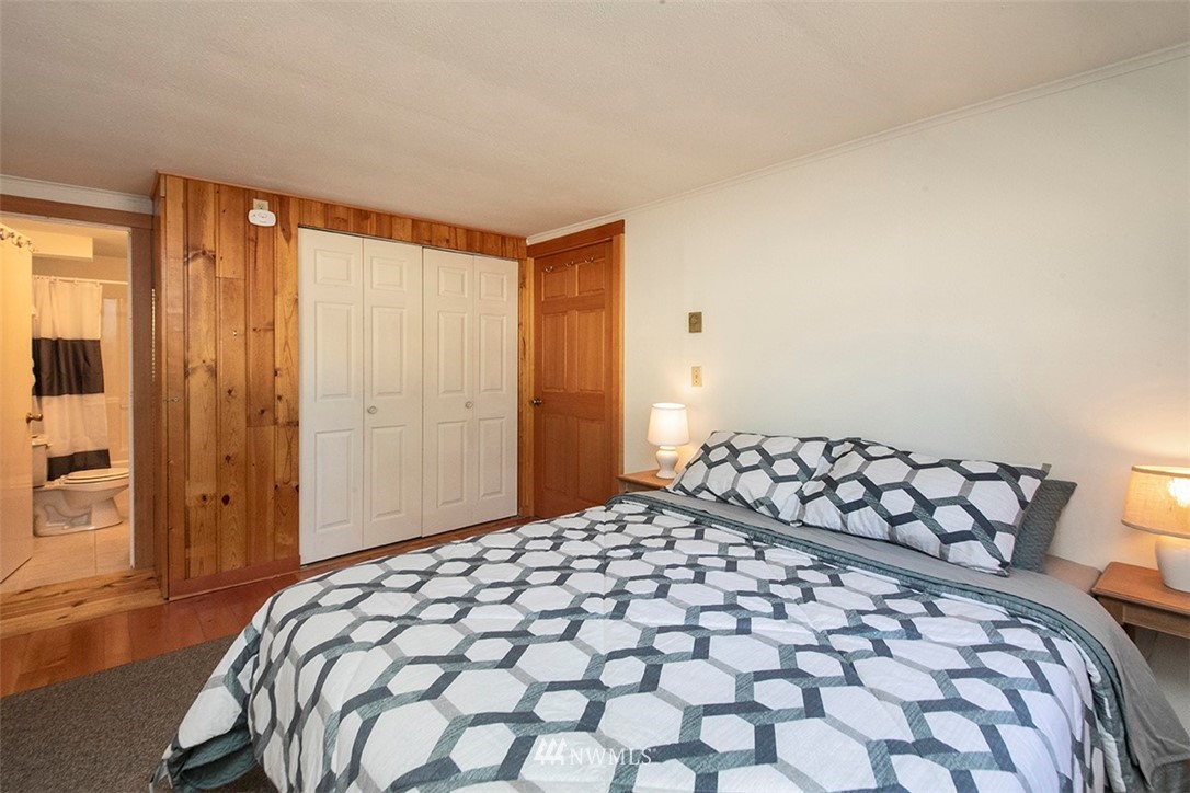 5837 Mutiny Bay Road Freeland, WA 98249 - Photo 13 of 40 a bedroom with a bed and a walk in closet