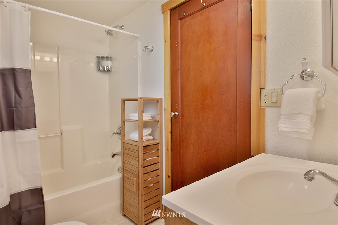 5837 Mutiny Bay Road Freeland, WA 98249 - Photo 14 of 40 a bathroom with a bathtub and a shower