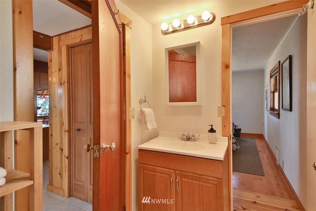 5837 Mutiny Bay Road Freeland, WA 98249 - Photo 15 of 40 a bathroom with a sink and a mirror