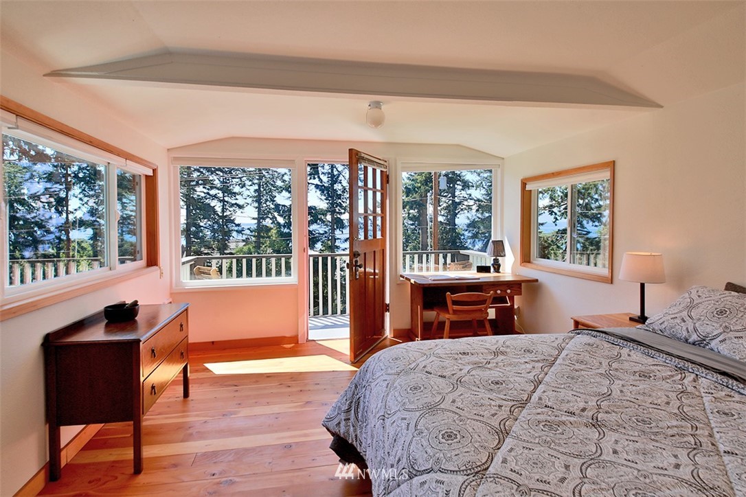 5837 Mutiny Bay Road Freeland, WA 98249 - Photo 21 of 40 a bedroom with a bed and wooden floor