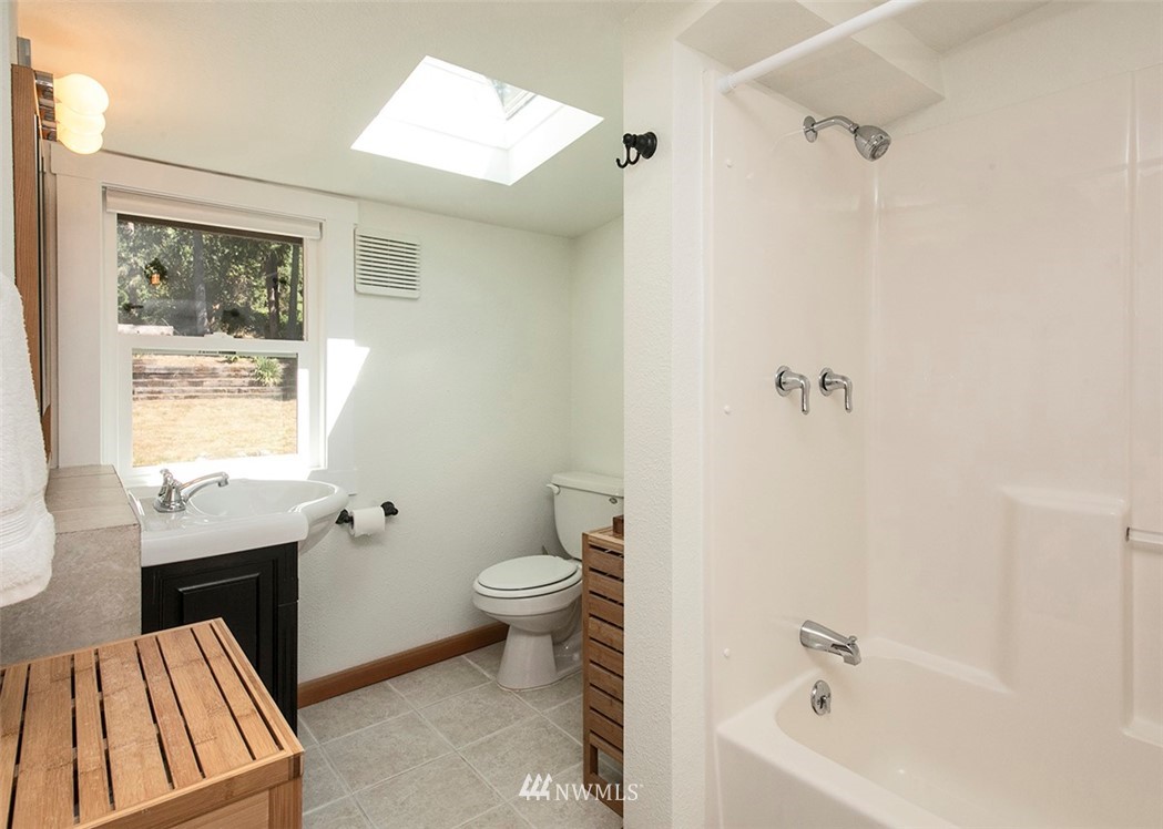 5837 Mutiny Bay Road Freeland, WA 98249 - Photo 25 of 40 a bathroom with a sink toilet and shower