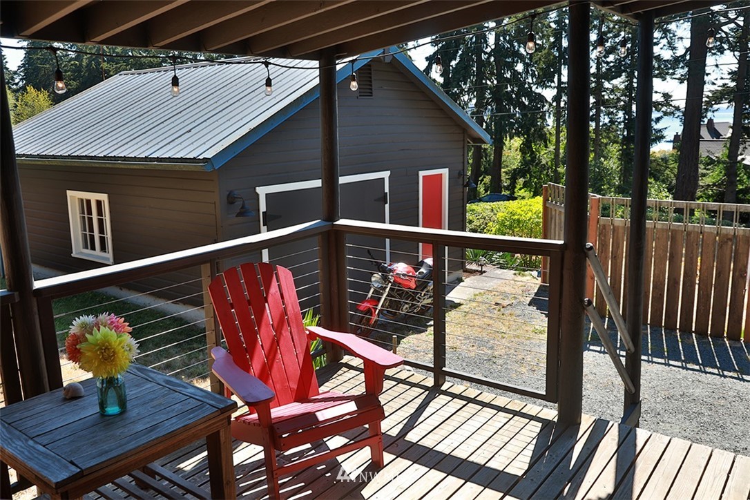 5837 Mutiny Bay Road Freeland, WA 98249 - Photo 28 of 40 a terrace with outdoor seating and wooden floor