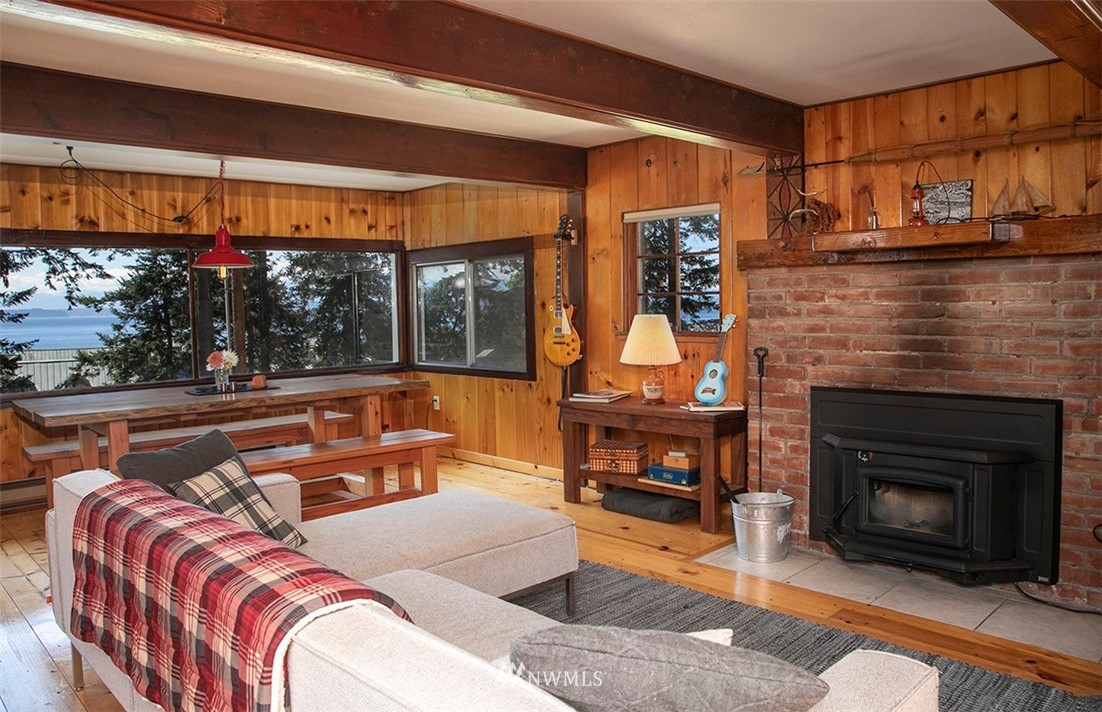 5837 Mutiny Bay Road Freeland, WA 98249 - Photo 7 of 40 a living room with a couch and a fireplace